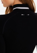 THE UPSIDE women’s black merino Wool Seamless Base Quarter Zip offers a soft & comfortable fit and features white striped ribbing on cuffs and collar. Designed for Après-ski and winter wear.
