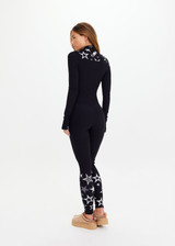 THE UPSIDE women’s black Superstar Nova Jumpsuit offers a firm & supportive fit in our jacquard stretch fabrication and features a mock neck zip through and thumb holes. Designed for Après-ski and winter wear.