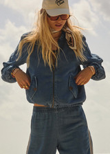 THE UPSIDE women’s blue denim Lykke Lexi Bomber Jacket, in a soft chambray fabrication, is made for a relaxed fit. This zip-through jacket features front pockets with branded tortoiseshell buttons. THE UPSIDE women’s blue denim Lykke Lexi Bomber Jacket, in a soft chambray fabrication, is made for a relaxed fit. This zip-through jacket features front pockets with branded tortoiseshell buttons.