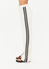 THE UPSIDE women’s cream Roma Pant is a true-to-size fit and features an elasticated waistband with drawcord, pockets and black and cream contrast stripes down sides. Perfect for everyday.