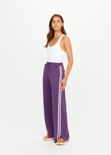 THE UPSIDE women's purple recycled Roma Pant is high-waisted with a drawcord, coated metal aglets, and side seam pockets. Perfect for travel or lifestyle.