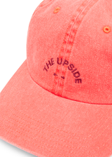 THE UPSIDE women's pink Soft Cap features a embroidered horseshoe logo on front and an adjustable strap at back with buckle. Made for lifestyle.