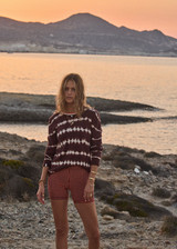 THE UPSIDE women's orange & navy check Solaris 5inch Spin Short is mid-rise and features an embroidered arrow logo at back. Made for yoga & pilates.