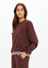THE UPSIDE women's brown organic cotton Toluca Lisel Crew Neck Sweater offers a relaxed fit with a dropped shoulder and features a ribbed neckline and cuffs. Made for lifestyle.