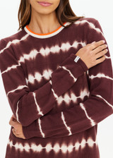 THE UPSIDE women's brown & cream tie dye organic cotton Amana Long Sleeve Knit is designed for a relaxed fit and features a contrast striped neckline in orange. Made for everyday.