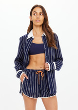 THE UPSIDE women's navy & white stripe Belize Bobbi Collared Shirt features a ruffled detail and sleeve cuff with button closure in linen fabrication. Made for lifestyle.