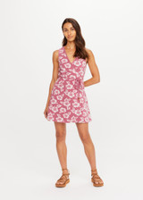 THE UPSIDE women's floral organic cotton Lahaina Maxine Wrap Mini Dress features a V neckline, wide straps and wooden bead ends on drawcord. Made for lifestyle.