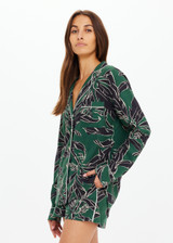 THE UPSIDE women's floral Tamara Rio Collared Shirt is a true-to-size fit featuring a green palm print, pearlised shell buttons and contrast cream piping. Made for lifestyle.