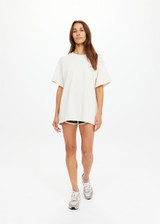 THE UPSIDE women's cream organic cotton Molokai Sammi Tee offers a oversized fit and features a green printed palm logo on front chest and back. Made for lifestyle.