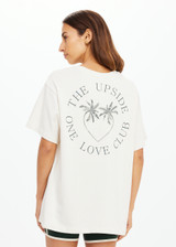 THE UPSIDE women's cream organic cotton Molokai Sammi Tee offers a oversized fit and features a green printed palm logo on front chest and back. Made for lifestyle.