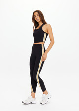 THE UPSIDE women's black Arcadia 25inch Legging is supportive and comfortable with recycled rib fabric, contrast tan panel, and cream bind details. Made for yoga & pilates.
