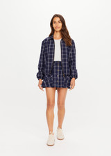 THE UPSIDE women's check Valencia Lexi Collared Jacket is relaxed fit with zip-through bomber style, collar, and front flap pockets with antique brass buttons. Made for lifestyle.