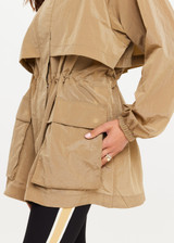 THE UPSIDE women's brown Rylan Anorak is relaxed fit, mid-length, made from tan wrinkled water-resistant fabric. Made for lifestyle.