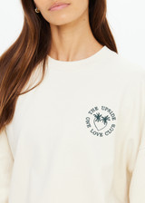 THE UPSIDE women's natural Molokai Paloma Crew is boxy fit with an embroidered green palm tree logo at front chest. Made for lifestyle.