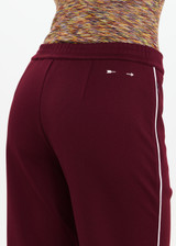THE UPSIDE women's maroon Mendoza Jackie Flare Pant is true to size and features cream piping along side seams and zipper pockets. Made for lifestyle.