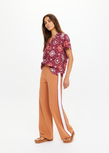 THE UPSIDE women's orange Lenzing viscose Marnie Wide-Leg Pant has a true-to-size fit with a high-rise elasticated waistband and welt pockets. Made for lifestyle.