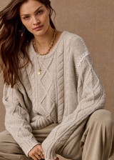 THE UPSIDE women's natural wool blend Xanthe Crew Neck Knit Sweater has a relaxed fit with cable knit and decorative blanket stitching. Made for lifestyle.