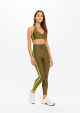 THE UPSIDE women's olive eco tech Oxford 25 Inch Midi Pant is designed for a supportive and comfortable fit and features mid-rise with lime contrast side binds. Made for high impact.