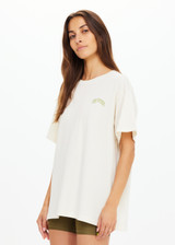 THE UPSIDE women's natural organic cotton Isadora Sammi Tee is designed for an oversized fit and features a printed logo in lime and blue with a soft rib neckline. Made for lifestyle.