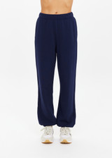 THE UPSIDE women's navy organic cotton Harrison Trackpant offers a relaxed fit and features an elasticated waistband with side pockets. Perfect for everyday comfort.