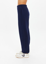THE UPSIDE women's navy organic cotton Harrison Trackpant offers a relaxed fit and features an elasticated waistband with side pockets. Perfect for everyday comfort.