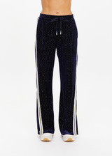 THE UPSIDE women's navy polka dot Spellbound Roma Pant is true to size and features metallic silver spots on velvet fabrication and side seam pockets. Made for lifestyle.