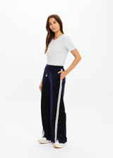 THE UPSIDE women's navy polka dot Spellbound Roma Pant is true to size and features metallic silver spots on velvet fabrication and side seam pockets. Made for lifestyle.