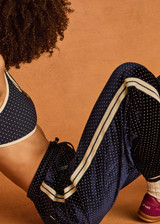 THE UPSIDE women's navy polka dot Spellbound Roma Pant is true to size and features metallic silver spots on velvet fabrication and side seam pockets. Made for lifestyle.