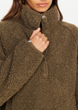 THE UPSIDE women's green recycled polyester Harlow Fleece Pullover is designed for a relaxed fit and features a quarter snap button opening and zip pockets. Made for lifestyle.