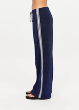 THE UPSIDE women's navy Galaxia Loretta Pant is designed for a mid to low rise fit and features elasticated waistband, drawcord with side seam pockets and knitted tape down sides. Made for lifestyle.