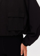 THE UPSIDE women's black Ace Shell Jacket is a water-resistant cropped zip-through jacket and features front pockets and an adjustable drawcord at waist. Made for running.