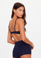 THE UPSIDE women's navy Palais Rib Capri Bra is designed to be worn under sheer garments and features a v neckline with adjustable straps in a soft ribbed fabrication. Made for lifestyle.