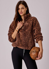 THE UPSIDE women's leopard Harlow Fleece Pullover is designed for a relaxed fit with raglan sleeves crafted from recycled sherpa fabrication and features zip pockets and an elasticated waistband and cuffs for warmth.