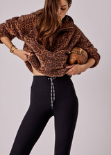 THE UPSIDE women's leopard Harlow Fleece Pullover is designed for a relaxed fit with raglan sleeves crafted from recycled sherpa fabrication and features zip pockets and an elasticated waistband and cuffs for warmth.