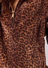 THE UPSIDE women's leopard Harlow Fleece Pullover is designed for a relaxed fit with raglan sleeves crafted from recycled sherpa fabrication and features zip pockets and an elasticated waistband and cuffs for warmth.