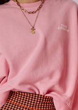 THE UPSIDE women's pink organic cotton Paloma Crew Neck Sweater offers a boxy fit and features a drop shoulder and The Upside logo printed on front chest. Made for everyday wear.