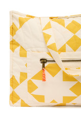 THE UPSIDE women's yellow large Etoile Quilted Tote Bag is designed in our star print and features a front external pocket with orange paracord zip pullers. Perfect for travel days.