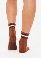 THE UPSIDE women's walnut brown Avalon Grip Sock features an anti-slip sole with midi ankle height, designed with navy and cream stripes, grip and logo. Made for yoga & pilates.