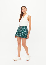THE UPSIDE women's green Racquet Cadiz Pleated Skirt features built-in shorts with pockets and two tone drawcord with silver tennis racket charms. Made for tennis, golf & pickleball.