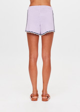 THE UPSIDE women's lilac organic cotton Amara Roller Knit Short is a relaxed fit featuring an elasticated waistband with drawcord and an open knit heart design down sides. Made for tennis, golf & pickleball.