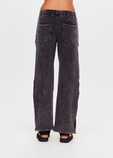 THE UPSIDE women's washed black Cosmic Wide Leg Shana Pant is a high waisted, wide-leg fit and features silver metal button snaps down leg that can be worn open.