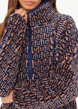 THE UPSIDE women's navy & camel Castilla Harlow Pullover is a relaxed pull over style fleece with raglan sleeves in our castilla "TU" design and features zip pockets, crafted from a recycled sherpa fabrication. Perfect for cooler weather.