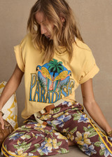 THE UPSIDE women's yellow organic cotton Paradise Jacob Tee is designed for an oversized fit and features a printed Paradise graphic on front. Made for everyday.