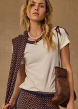 THE UPSIDE women's cream organic cotton Zahra Rib Tee features a rib fabrication and striped neckline in navy and tan. Made for lifestyle.THE UPSIDE women's cream organic cotton Zahra Rib Tee features a rib fabrication and striped neckline in navy and tan. Made for lifestyle.
