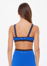 THE UPSIDE women's blue Montage Rory Scoop Knit Sports Bra is mid coverage, with a knitted scooped bra neckline, cream side pannels and a brown elasticated underbust. Made for yoga & pilates.