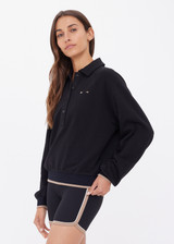 THE UPSIDE women's black organic cotton Collared Elle Polo is a relaxed fit long sleeve with a mocha stripe along ribbed hem and cuffs. Made for everyday wear.