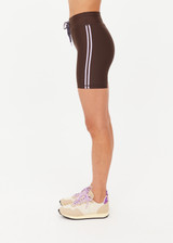 THE UPSIDE women's brown eco tech Oxford 5Inch Spin Short offers a mid rise with lilac coloured binds down side seams and an elastic drawcord through waist. Made for high impact.