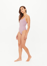THE UPSIDE women's stripe jacquard Miami Flow Scoop One Piece features adjustable elastic straps with a scoop neckline in a striped lilac and chocolate design. Made for swim.