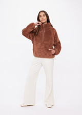 THE UPSIDE women's brown Harlow Fleece Pullover features quarter zip, elastic cuffs and waist, and is made from a recycled sherpa fabrication. Made for lifestyle.