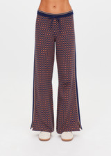 THE UPSIDE women's brown organic cotton Lumiere Juniper Knit Pant is a straight leg pant with a geometric star pattern, a soft elasticated waistband with drawcord and side seam pockets. Made for lifestyle.